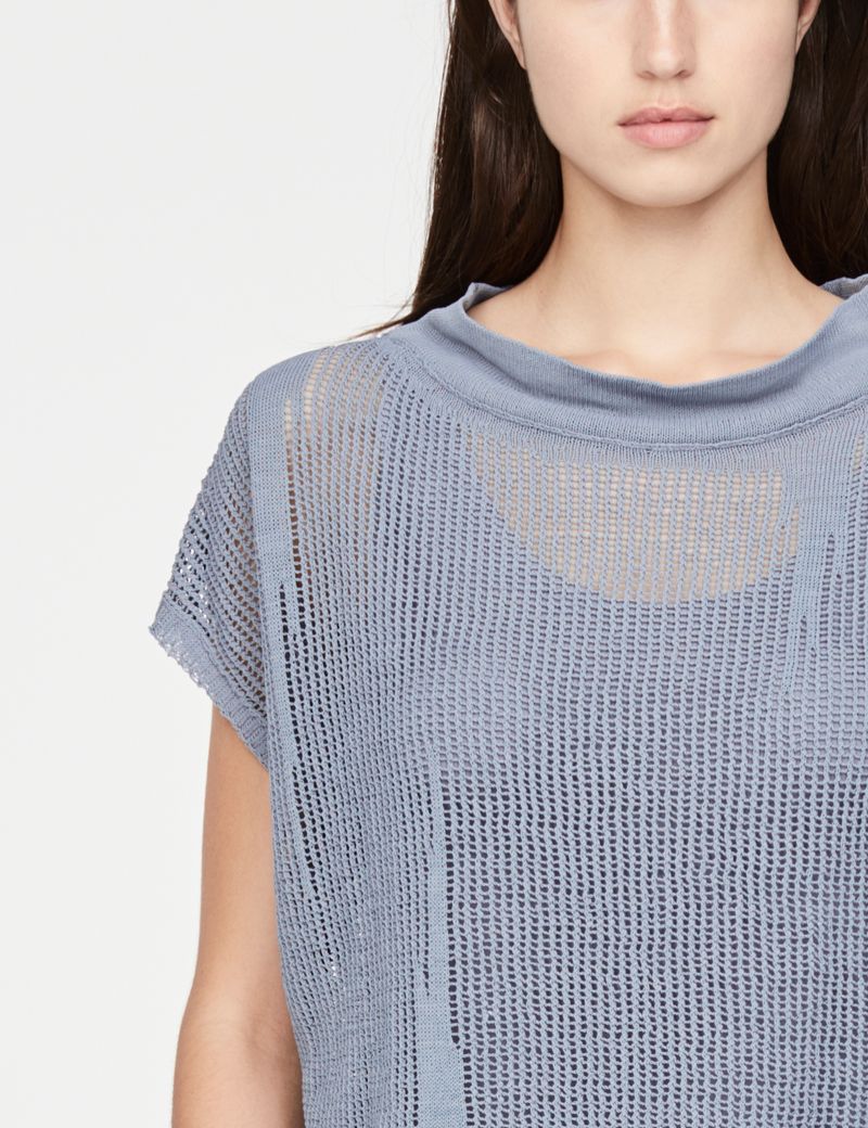 Sarah Pacini trui met gaatjes - kapmouwen