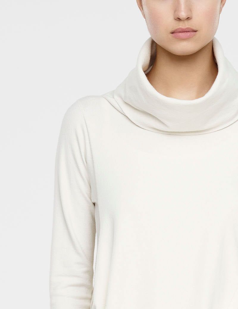 White long sleeve sweater with side slits by Sarah Pacini