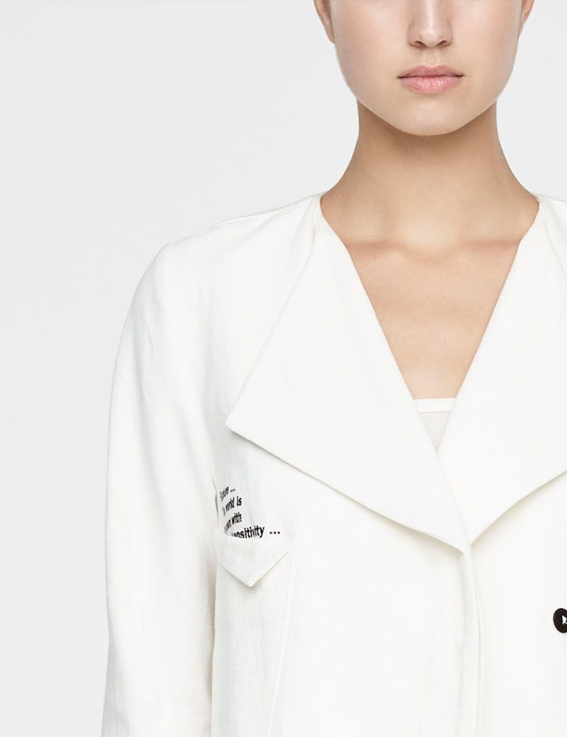 White linen asymmetrical jacket by Sarah Pacini